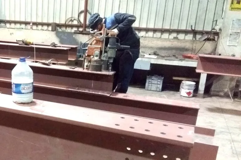 İki kaynakçının astar boyalı çelik kiriş üzerinde kaynak yapması